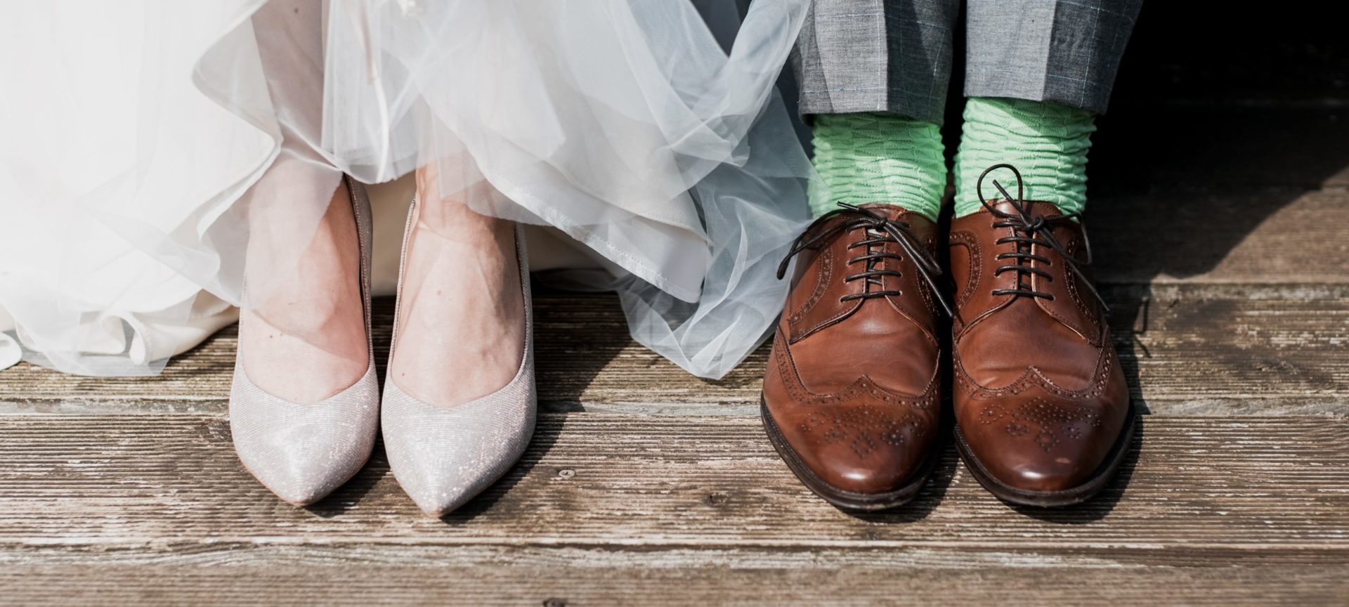 Picture of the bride and groom wearing wedding shoes. 